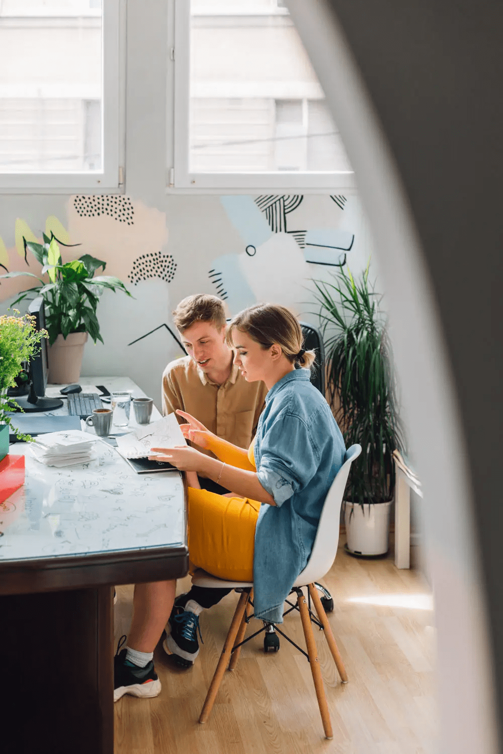 Man and woman working together in a cute office