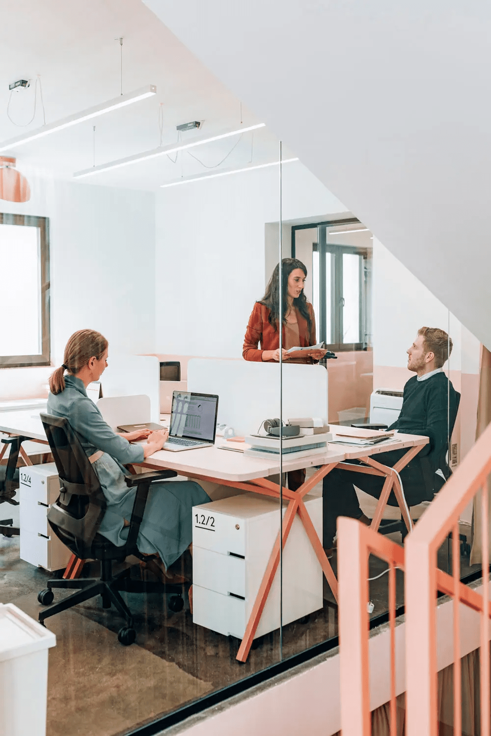 Large team of coworkers working together in a big office