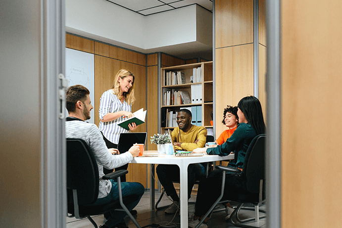 A team of professions around a laptop talking