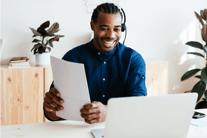 Customer service agent smiling at laptop