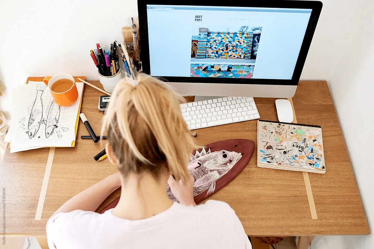 Woman designing designing a website to sell her artwork