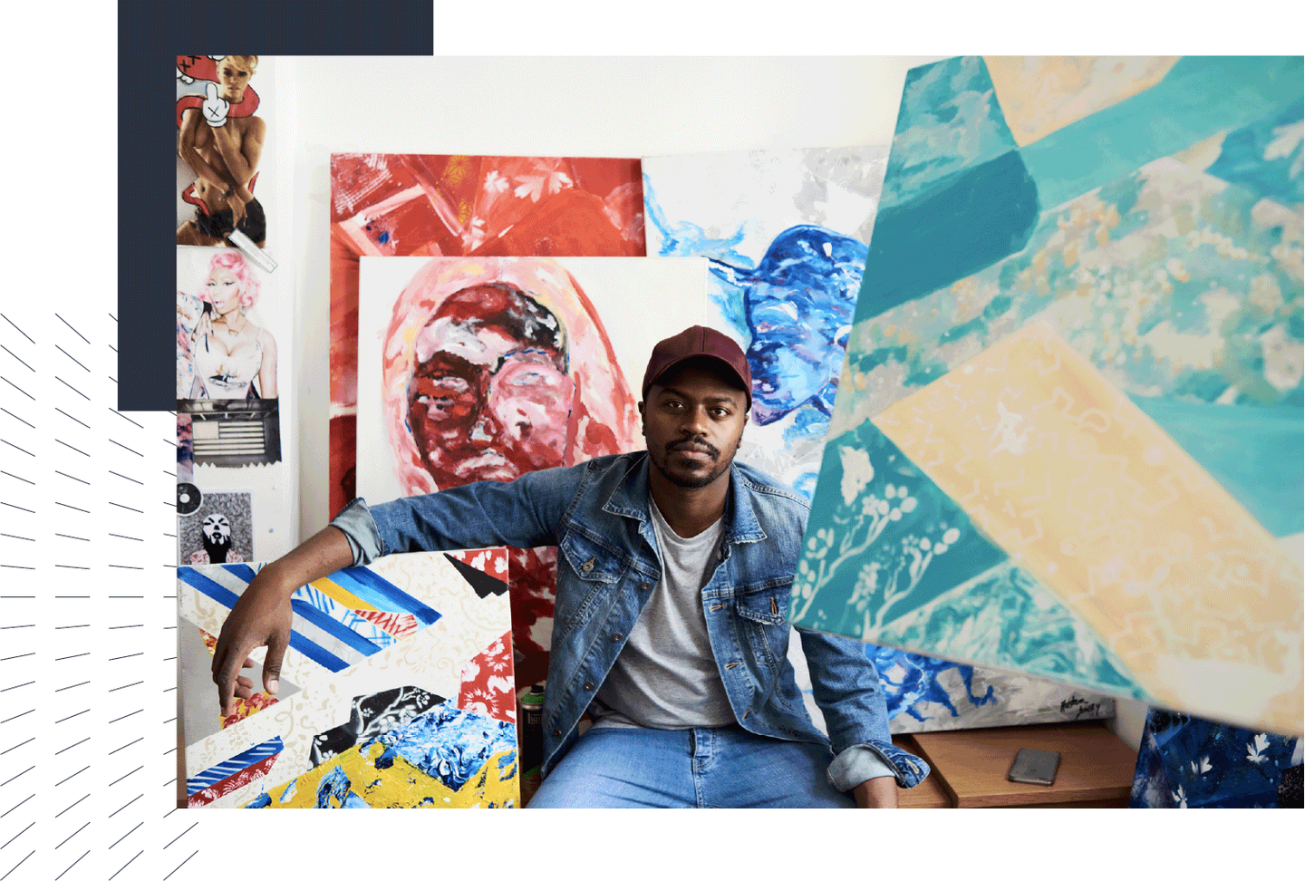 Artist sitting in front of their paintings