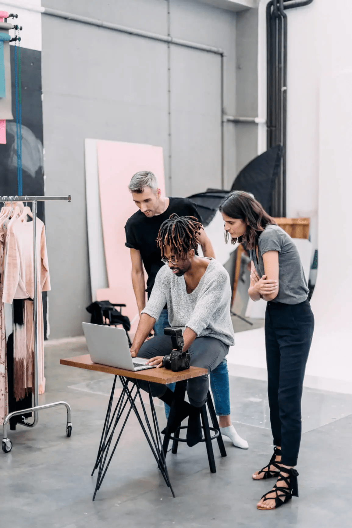 A team of people looking at a laptop