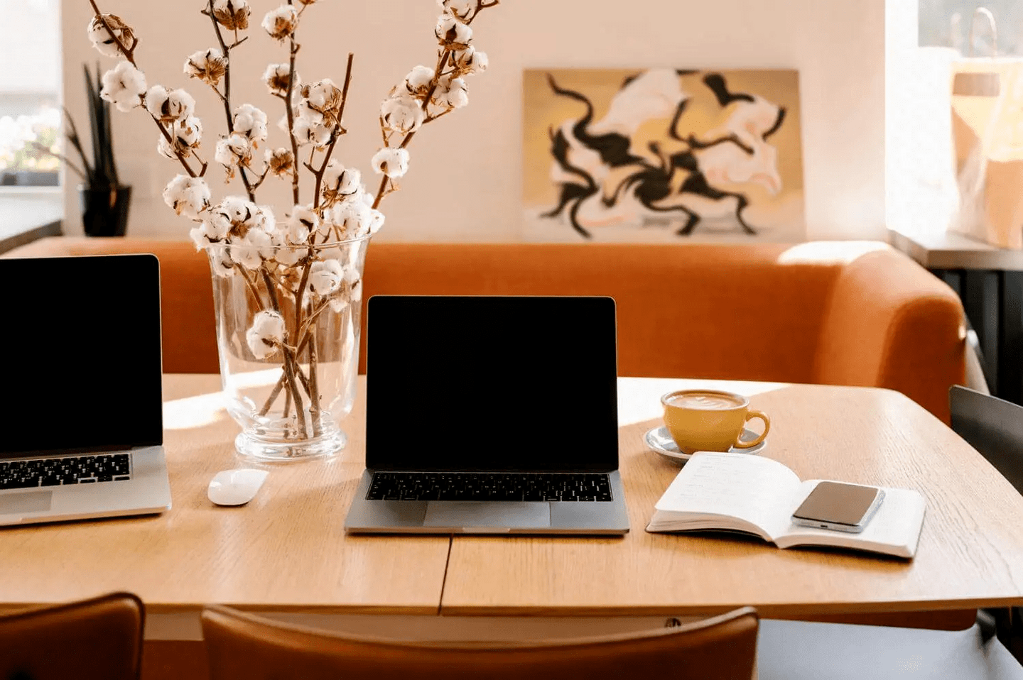 Laptops on a table inside of a nice cafe