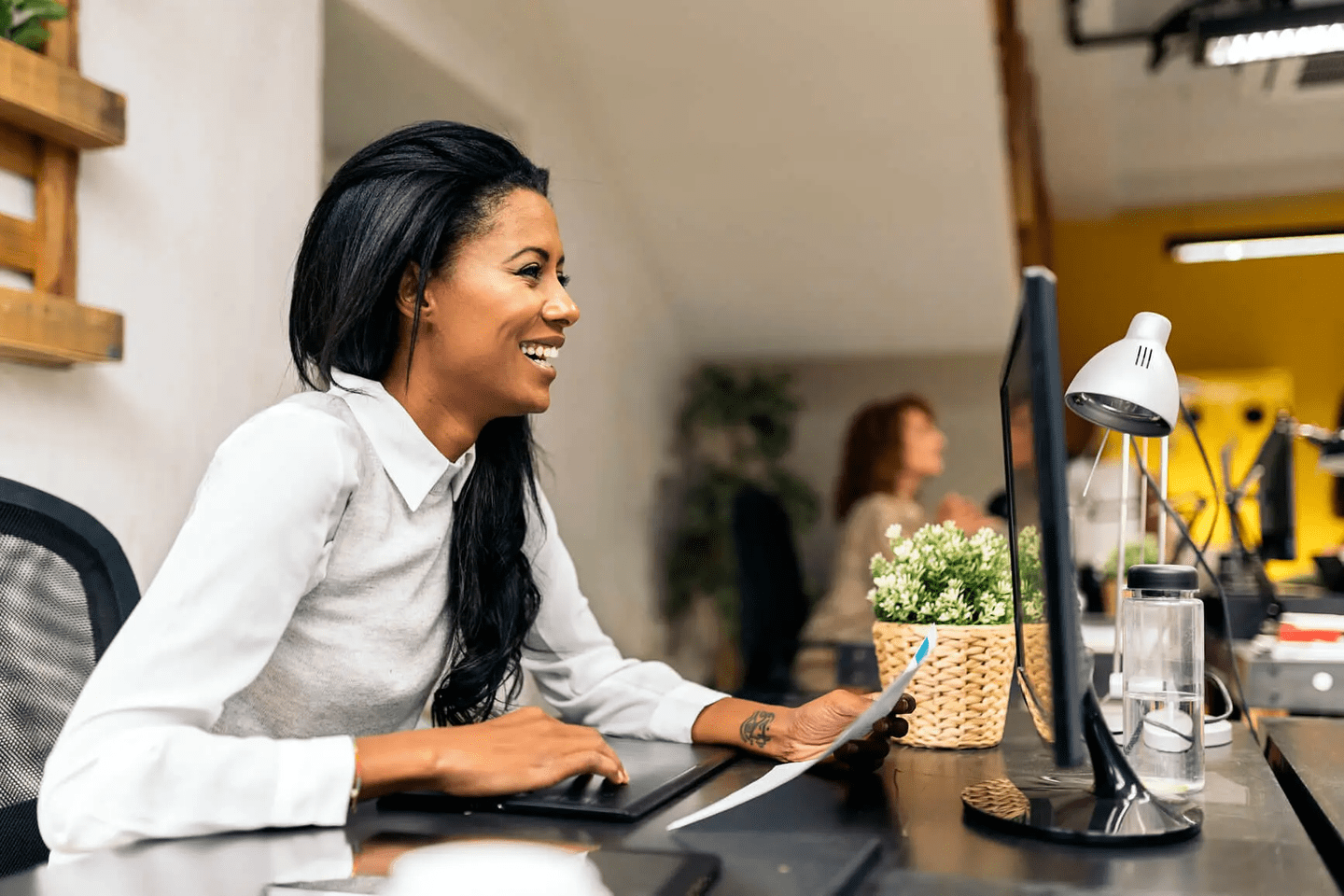 Woman smiling at computer