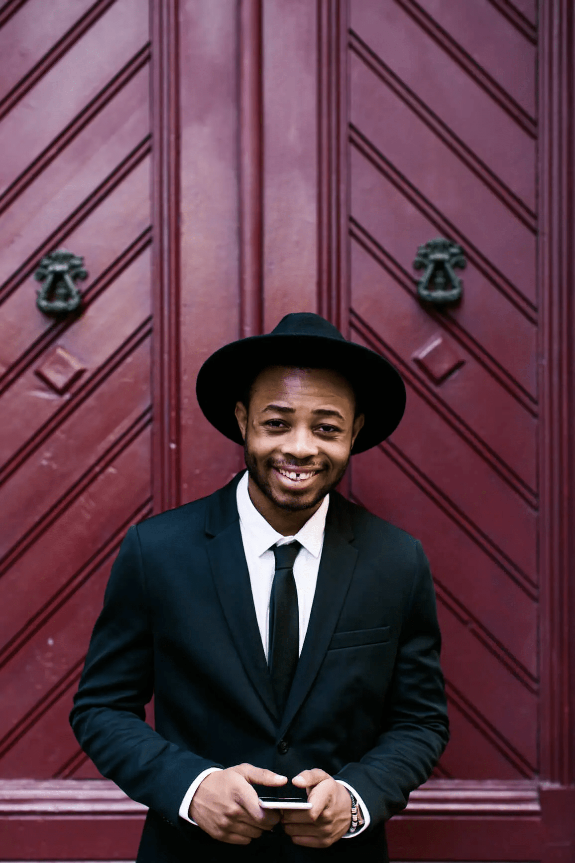 Man smiling while holding his phone