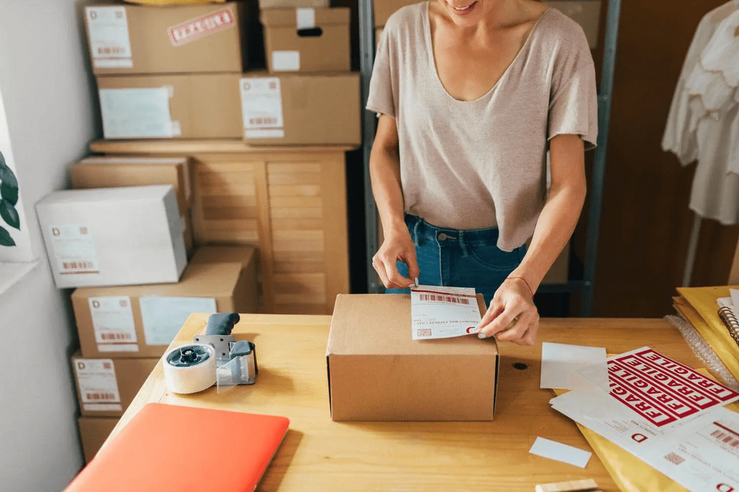 A woman preparing a package of a recent sell on her ecommerce site