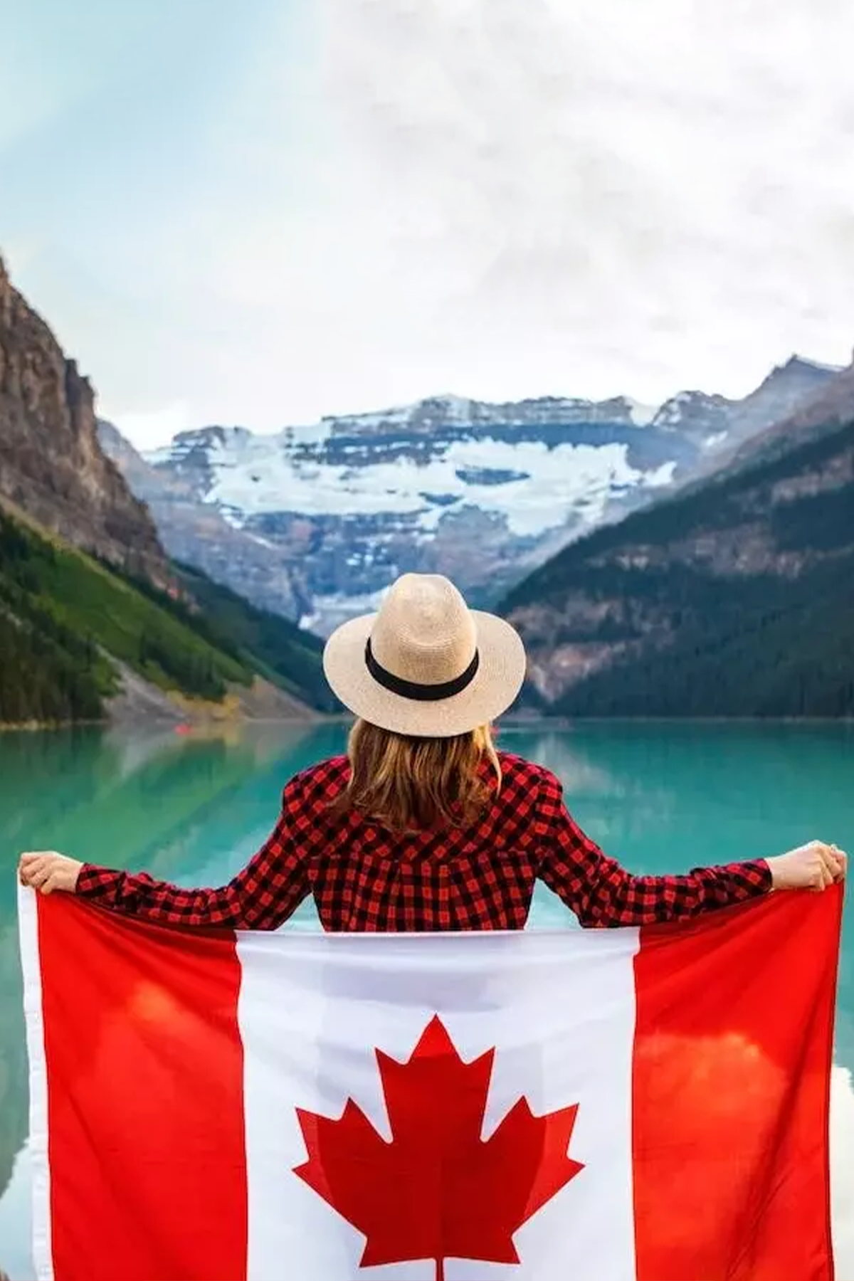 Girl on a mountain with a Canadian flag