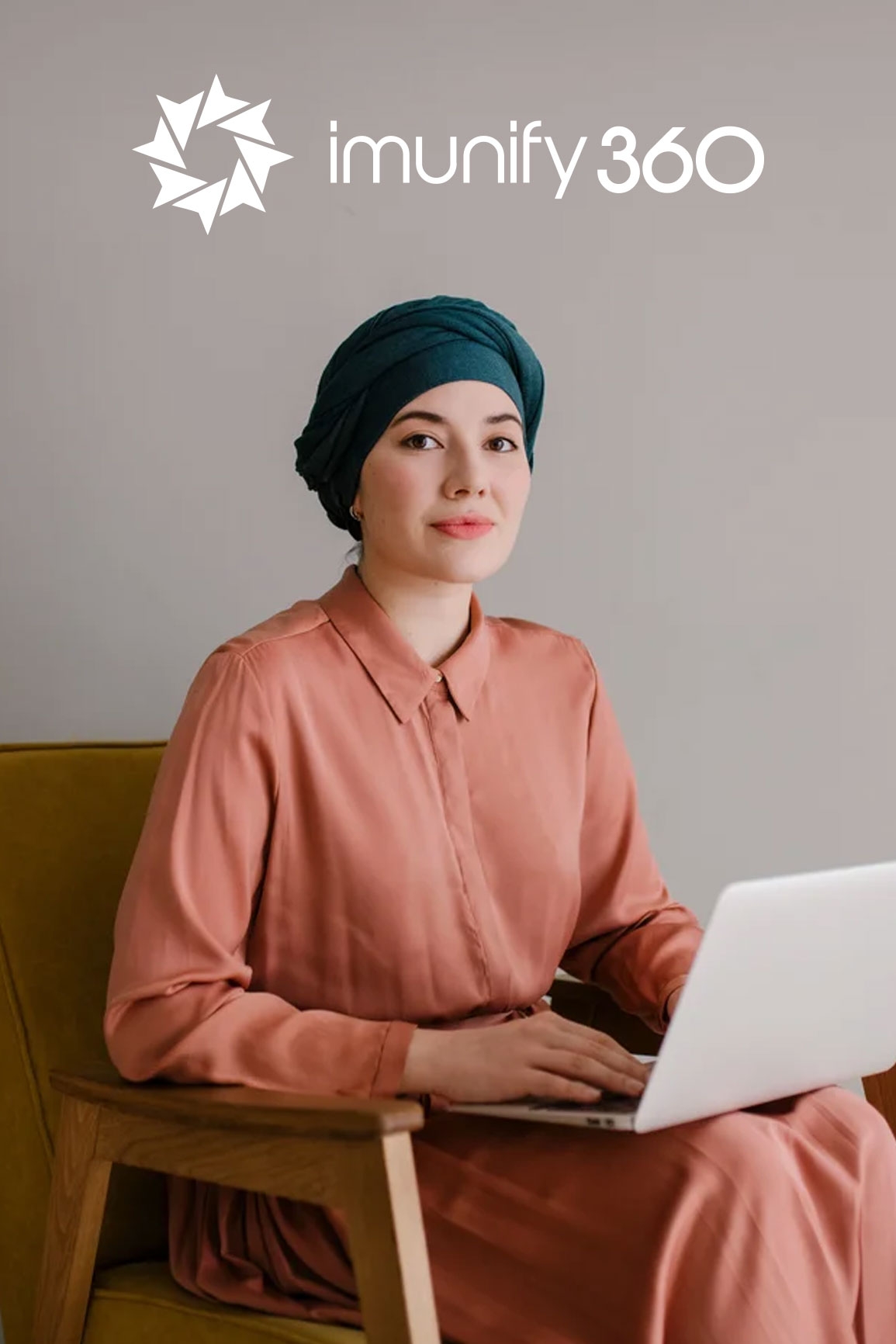 a women with a laptop on her lap smiling